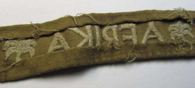 Attractive - and clearly worn! - WH cuff-title (ie. 'Ärmelstreifen') entitled: 'Afrika' (being a period-shortened example that comes in an overall nice- ie. issued and clearly worn ie. once tunic-attached, condition)