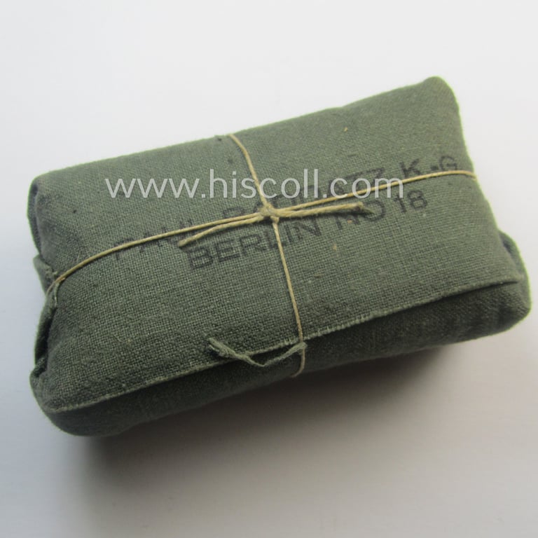 WH (Heeres, Luftwaffe etc.) greenish-coloured- and/or linnen-based bandage-package (or: 'Verbandpäckchen') dated: '1939' that comes in a never used- (ie. 'virtually mint- ie. unissued'-), condition