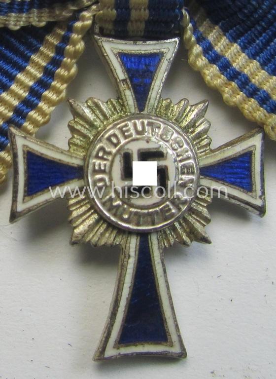 Miniature of an: 'Ehrenkreuz der deutschen Mutter - zweite Stufe' (or: silver-class mothers'-cross) being a non-maker-marked example that comes in an overall nice- (albeit moderately worn- ie. used-), condition