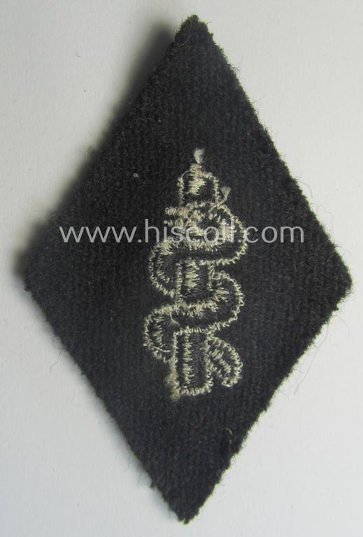 Waffen-SS-pattern, machine-embroidered and/or black- and white-coloured sleeve-insignia (ie. 'Ärmelraute') depicting a so-called: 'Aesculapus'-sign as was used and intended to signify membership within the 'SS-Sanitätsdienst'