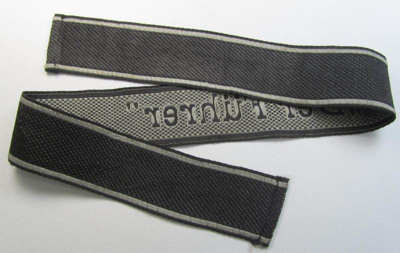 Stunning, Waffen-SS, 1943-pattern cuff-title (ie. 'Ärmelstreifen') depicting the machine-woven Latin script text in silver-grey linnen, as was intended for a member of the: 'SS-Regiment “Der Führer”