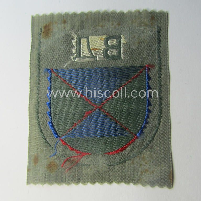 Eastern- ie. Russian volunteer (ie. Cossack-) related armshield as executed in the neat 'BeVo'-weave pattern depicting the interwoven 'Cyrillic' characters: 'BA' (as was intended for the Russian volunteers serving within the 'Don Cossacks')