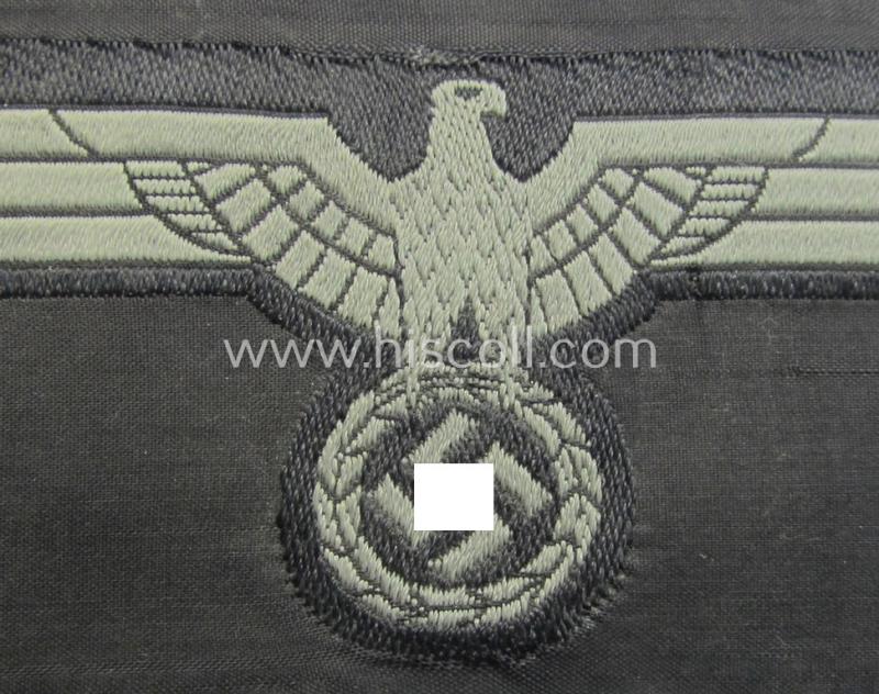 Later- (ie. mid-war-) period, WH (Heeres) 'Panzer'-type breast-eagle (ie. 'Brustadler für Panzertruppen') being a 'virtually mint- ie. unissued' example as executed in bluish-grey-coloured linnen on a black-coloured background