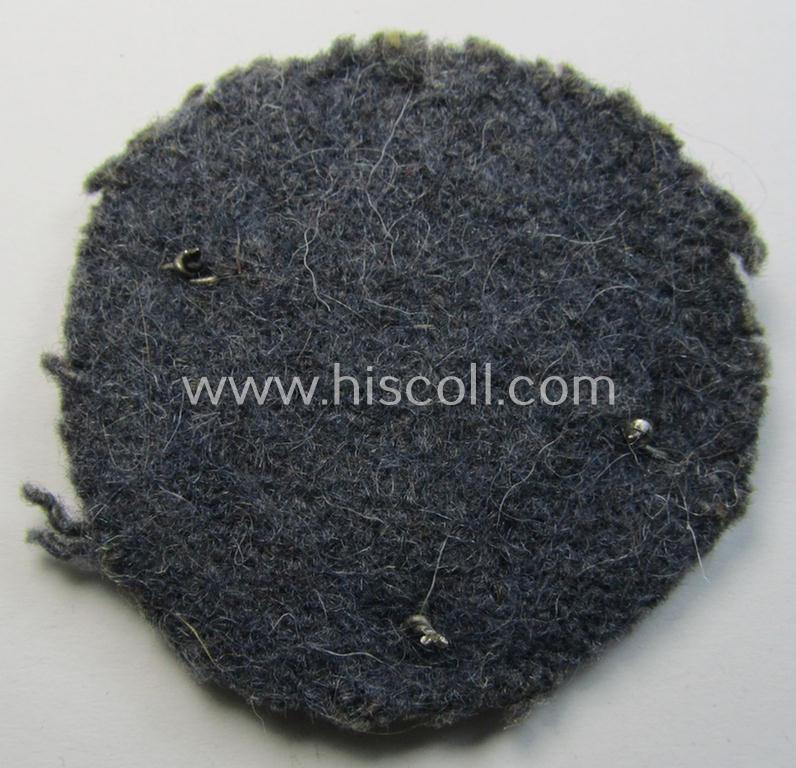 WH (Luftwaffe) so-called: 'Kraftfahrbewährungs-Abzeichen in Bronze' (or: bronze-class drivers'-proficiency-badge) that comes mounted onto its piece of blue-grey-coloured wool as most certainly issued- and/or clearly worn, condition