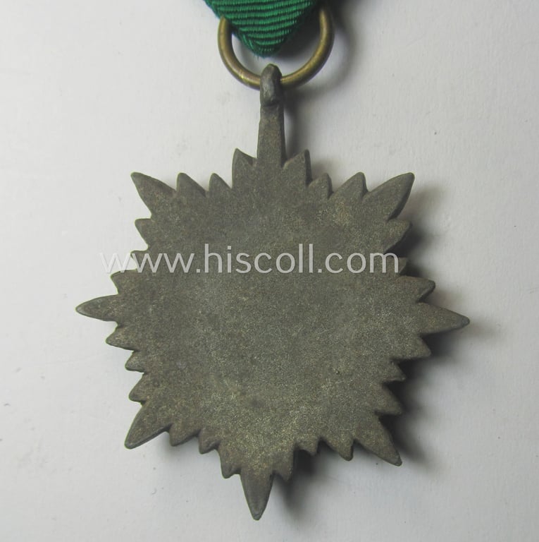WH-related 'Verdienstauszeichnung für Angehörige der Ostvölker, 3. Kl. in Bronze ohne Schwn.' (being a 'Feinzink'-based example that comes mounted onto its period ribbon ie. 'Bandabschnitt')