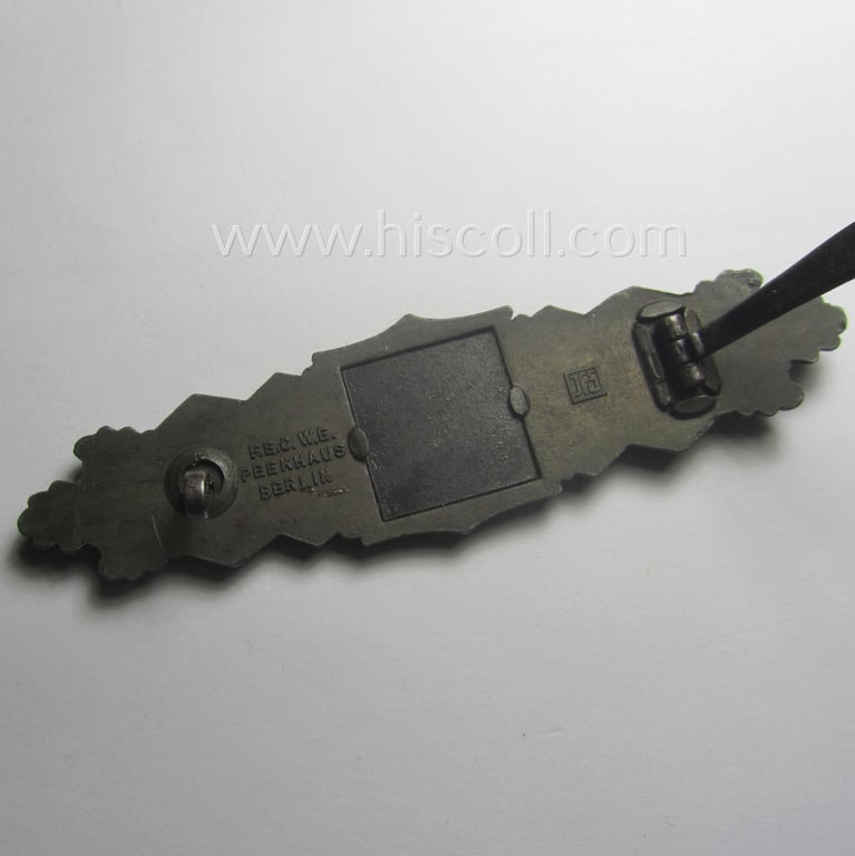 'Nahkampfspange in Bronze' (or: bronze-class close-combat clasp ie. CCC) being a neatly maker-marked- and/or minimally converse-shaped specimen as was produced by the: 'JFS'- (ie. 'Joseph Feix u. Söhne'-) company