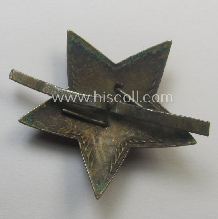 Unusual item that originated from a German soldier: a Russian, larger-sized and/or WWII-period, enamelled star-shaped cap-badge showing the communist logo on a bright-red-coloured surface