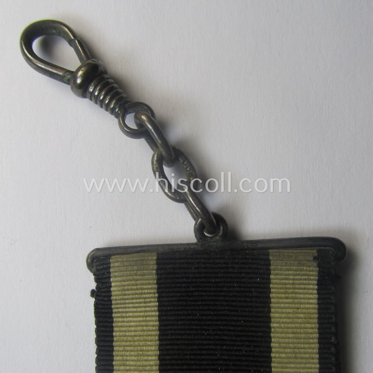 WWI-period: 'Eisernes Kreuz II. Klasse' being a typical maker- (ie. 'K.A.G.'-) marked example that comes mounted onto an unusually confectioned ribbon