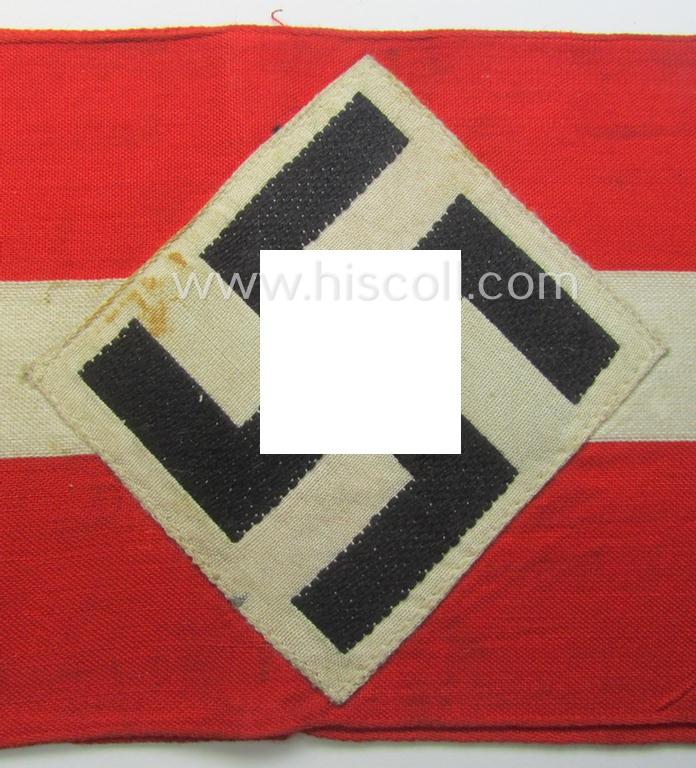 'Standard-issued'-pattern (ie. entirely woven) pattern, bright-red-coloured HJ- (ie. 'Hitlerjugend'-) related armband (ie. 'Armbinde') being a moderately worn- ie. used example that misses its 'RzM'-etiket