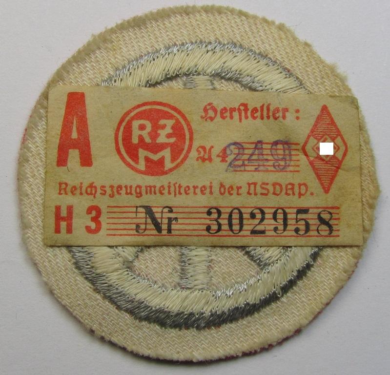 Attractive example of a HJ ('Hitlerjugend') 'Motor-HJ Prüfungsabzeichen' (or: motor-proficiency badge) being an example of the silver-class that still retains its period-attached 'RzM'-etiket