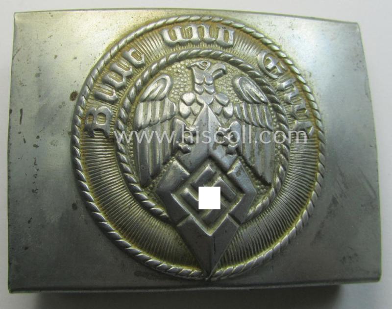 Attractive, HJ (ie. 'Hitlerjugend') silver-coloured- (ie. typically steel-based and 'crank-catch-variant'-pattern) belt-buckle being a neatly maker- (ie. 'RzM M4/42'-) marked example that comes in a just moderately used- ie. worn condition, as...