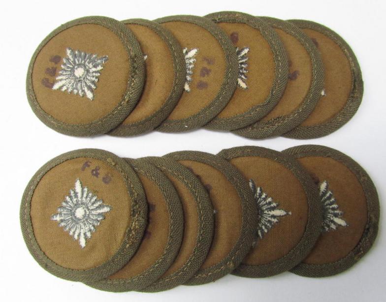 Neat, WH (Heeres) 'tropical-pattern'-, machine-embroidered rank-insignia (ie. roundel) being a neatly maker- (ie. 'F.& S.'-) marked example, as was executed in greyish-blue-coloured linnen, as was intended for an: 'Oberschütze'