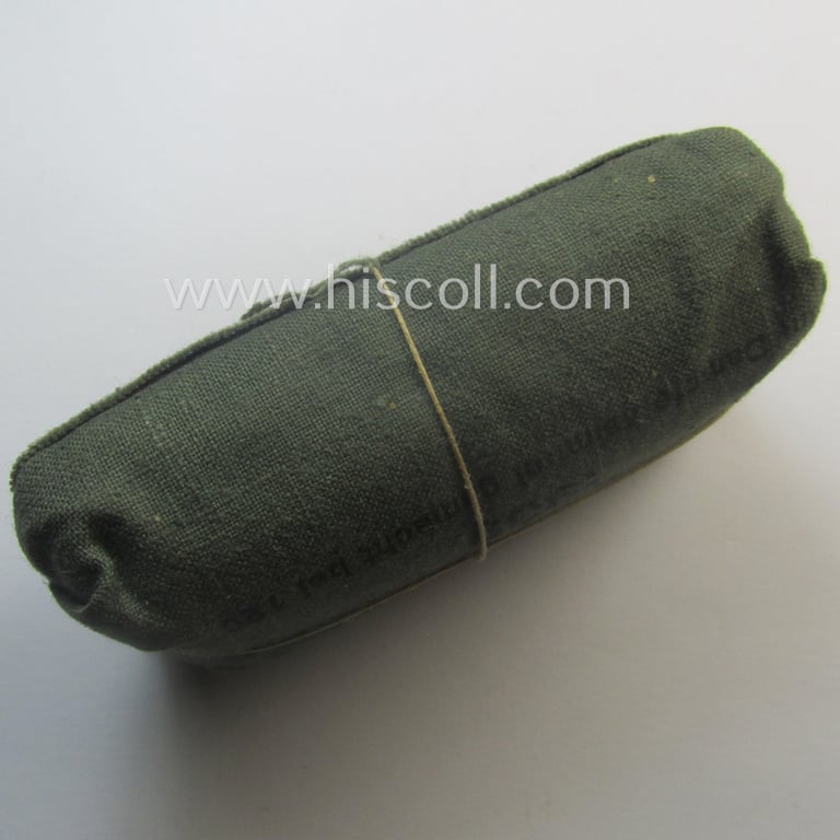 WH (Heeres, Luftwaffe etc.) greenish-coloured- and/or linnen-based bandage-package (or: 'Verbandpäckchen') dated: '1939' that comes in a never used- (ie. 'virtually mint- ie. unissued'-), condition