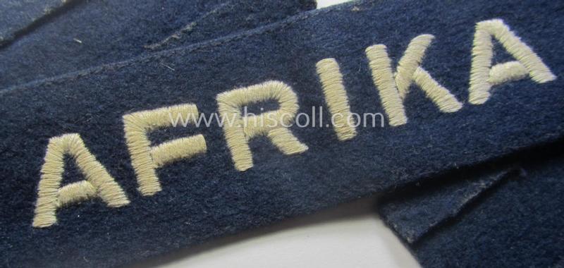 Darker-blue toned, WH (Luftwaffe) cuff-title (ie. 'Ärmelstreifen') entitled: 'Afrika' (being a full-length example that comes in an issued-, used and/or carefully tunic-removed, condition)
