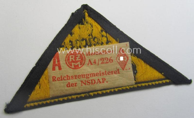 'HJ' ('Hitlerjugend') district-triangle (ie. 'Gebietsdreieck') entitled: 'Reichs-deutsche Jugend Ausland' being an (I deem) minimally worn- ie. used specimen that retains its 'RzM'-etiket