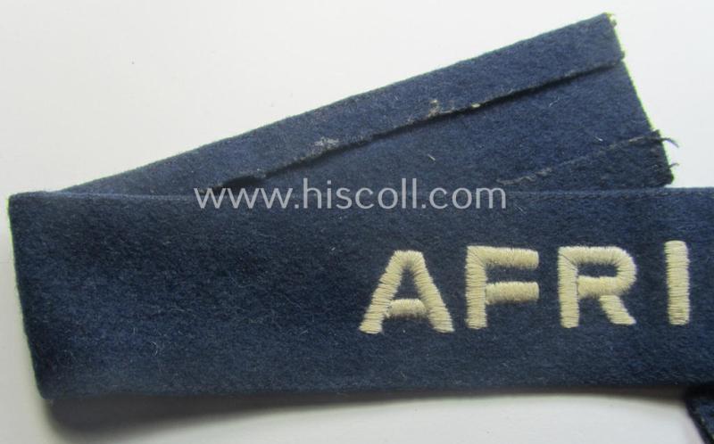 Darker-blue toned, WH (Luftwaffe) cuff-title (ie. 'Ärmelstreifen') entitled: 'Afrika' (being a full-length example that comes in an issued-, used and/or carefully tunic-removed, condition)