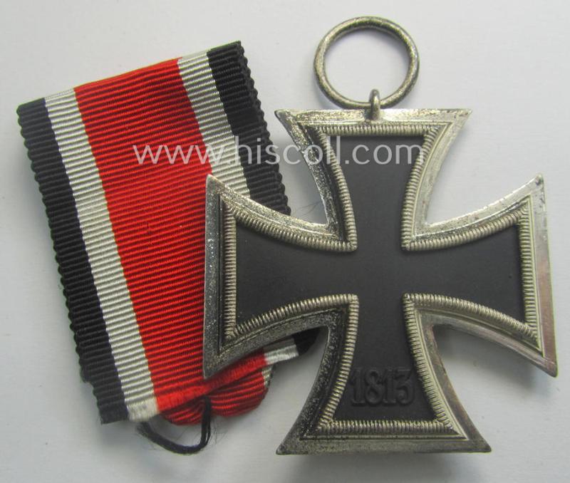 'EK II. Klasse' being a maker- (ie. '4'-) marked example that comes together with its original- and once-mounted ribbon (ie. 'Bandabschnitt') as was produced by the maker (ie. 'Hersteller'): 'Steinhauer u. Lück'