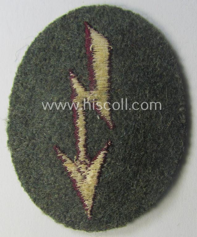 WH (Heeres) trade- and/or special-career-insignia (ie. machine-embroidered 'signal-blitz') example as executed in bordeaux-coloured linnen as was specifically intended for a soldier within the: '(Nebel)Werfer-Trpn.'