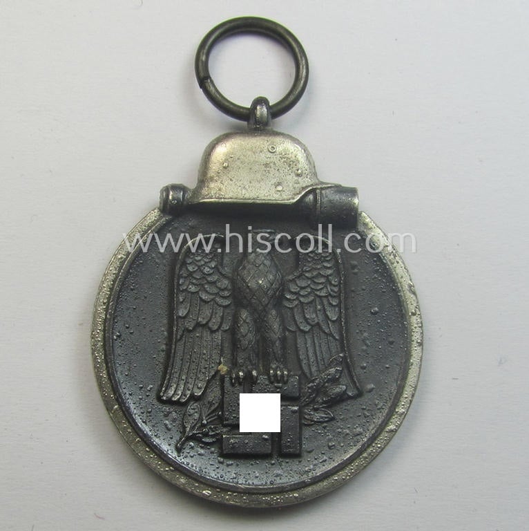 Medal-set: 'Winterschlacht im Osten 1941-42' being a non-maker-marked- (and/or 'Feinzink'-based) specimen that comes together with its (minimally confectioned) ribbon (ie. 'Bandabschnitt')