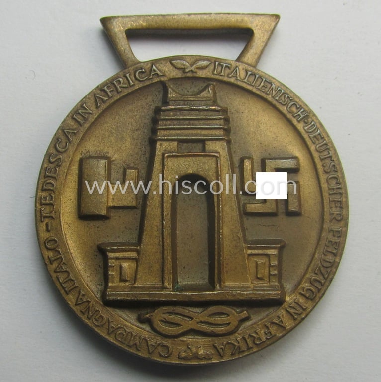 Golden-bronze-coloured (and 'Buntmetall'-based!) example of a: 'Deutsch-Italienische Feldzugsmedaille' (or: German-Italian campaign-medal) that came together with its (full length- and 'virtually mint- ie. unissued') piece of original ribbon