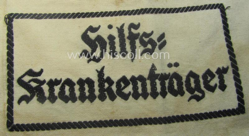 Beige-white-coloured- and/or linnen-based armband (ie. 'Armbinde') as was executed in the 'thicker-styled' fabric as was intended for WH (Heeres) staff-members working as: 'Hilfs-Krankenträger'