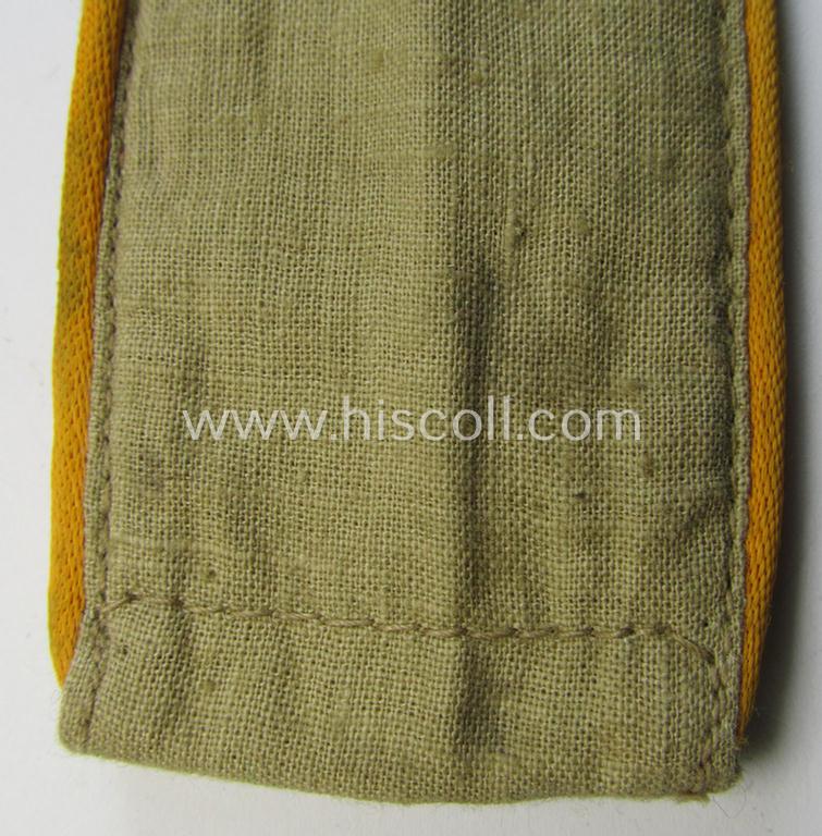 Single, WH (Luftwaffe) tropical-issued, EM-type-shoulderstrap as executed in beige-coloured linnen (as was specifically intended for usage on the tropical-shirts ie. tunics) as was intended for a: 'Soldat der Flieger- o. Fallschirmjäger-Truppen'