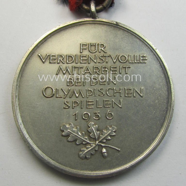 'Deutsche Olympia-Erinnerungsmedaille 1936' being a non-maker-marked example that comes mounted onto its original ribbon (ie. 'Bandabschnitt')