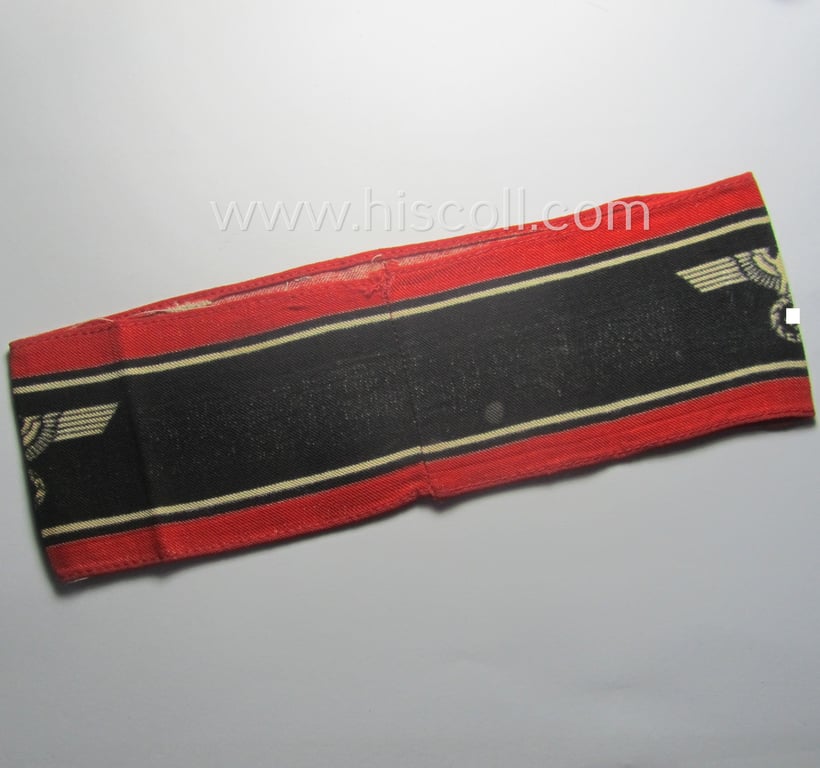Typically printed- and/or later-war-period, bright-red- and/or black-coloured so-called: 'Deutscher Volkssturm'-armband (ie. 'Armbinde') that comes in an overall nice- (I deem just moderately used- and/or worn-), condition