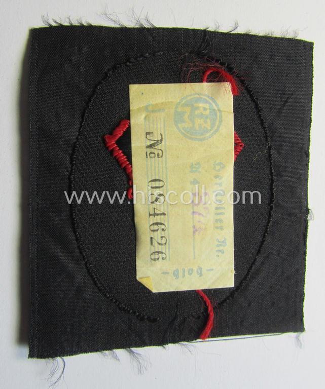 Superb - and never used- nor worn! - N.S.K.K.- (ie. 'National-Socialistisches Kraftfahr-Korps'-) related armbadge as was intended for an: 'N.S.K.K.-Sanitäts-Unterführer o. Mann' (ie. 'Feldscher') that still retains its 'RzM'-etiket