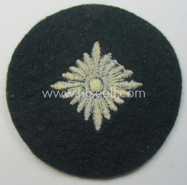 WH (Heeres) rank-insignia (ie. silver-grey-coloured and machine-embroidered 'roundel') as intended to identify a soldier with the rank of: 'Oberschütze', 'Oberjäger' etc. that comes in a 'virtually mint- ie. unissued', condition