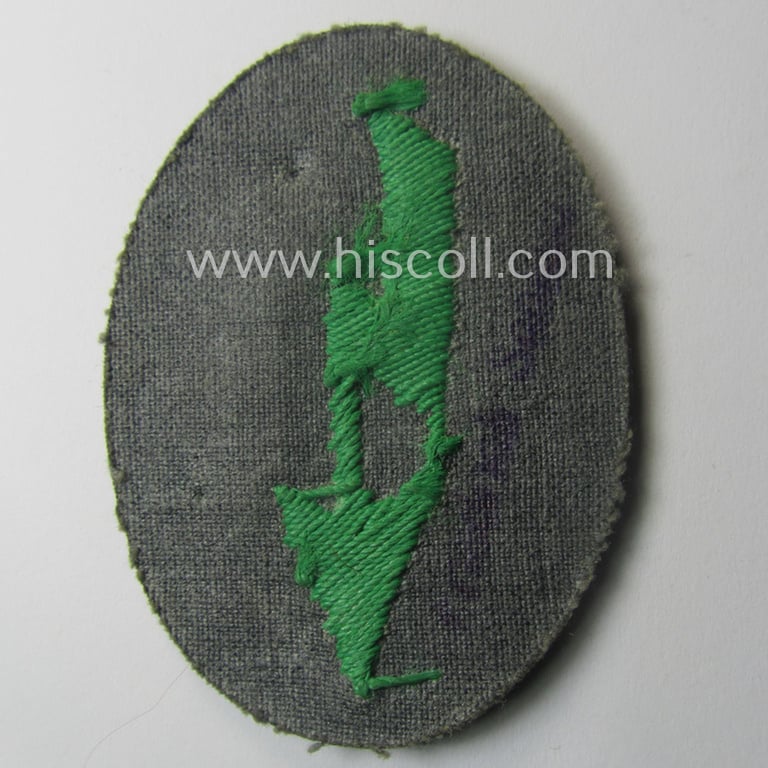 WH (Heeres) trade- and/or special-career-insignia ie. hand-embroidered 'signal-blitz' being a maker-marked example as executed in green-coloured linnen as was specifically intended for a soldier within the: 'Jäger- o. Geb.Jäger-Trpn.'