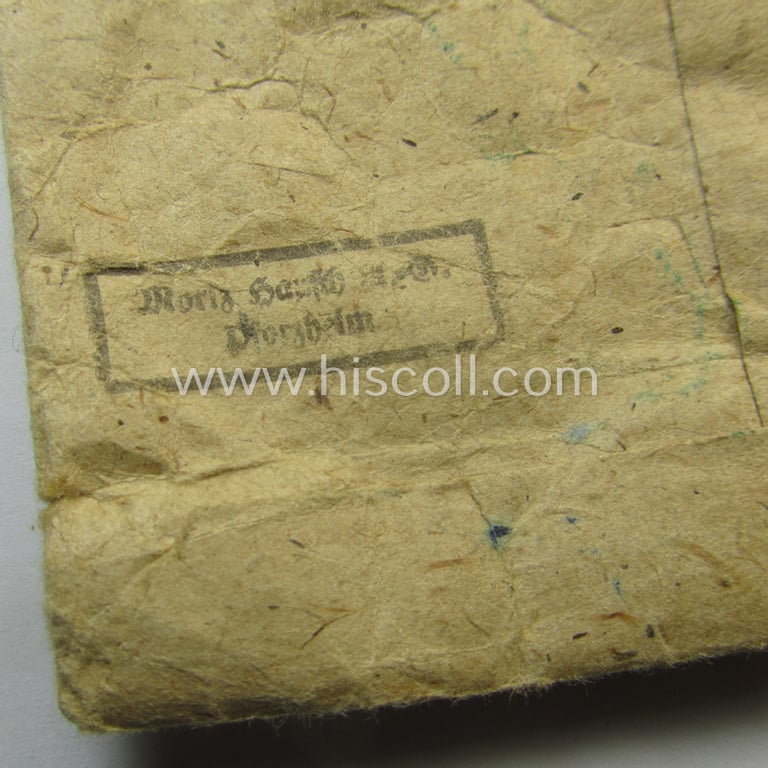 Unusual, silver-class wound-badge (or: 'Verwundeten-Abzeichen in Siber') being a maker- (ie. '127'-) marked example that comes stored in its original (damaged), carton-based pouch by the maker (ie. 'Hersteller'): 'Moriz Hausch A.-G.'