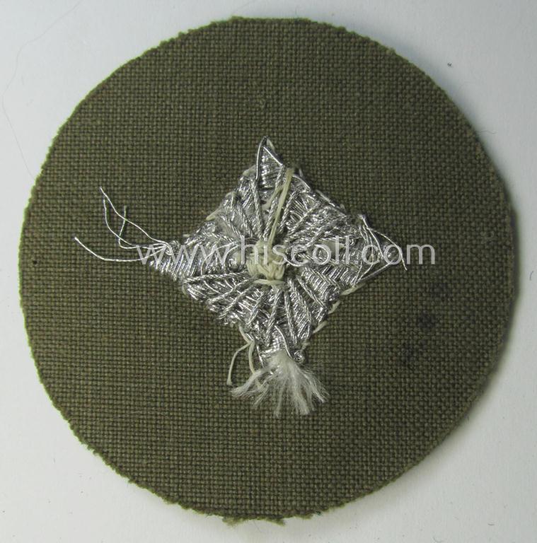 WH (Heeres) rank-insignia (ie. arm-roundel) as was specifically intended for usage by an: 'Oberschütze' (being an interesting hand-embroidered example as executed in silverish-coloured braid onto a darker-green-coloured background)