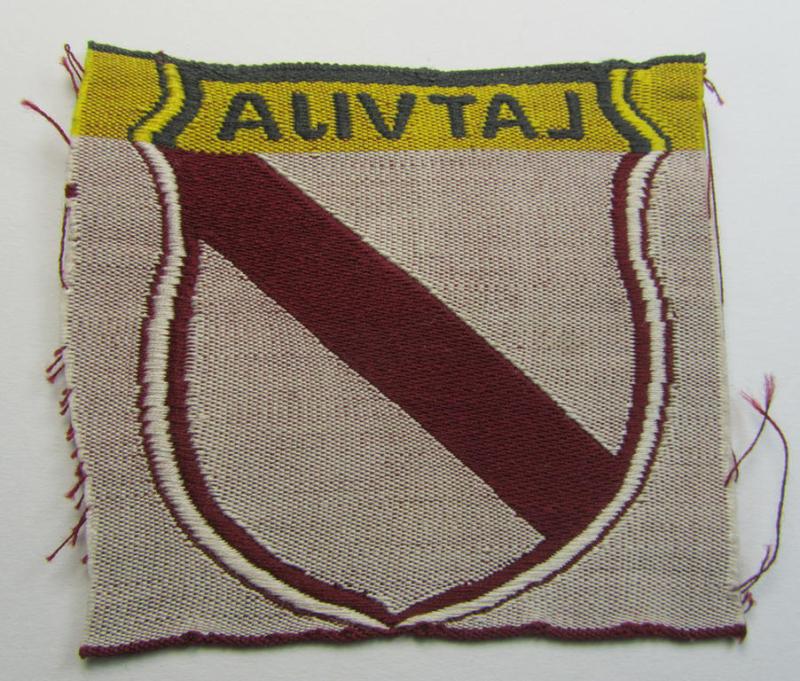 Superb - and truly rarely seen! - locally produced(!), 'Waffen-SS'-type armshield as executed in the so-called: 'semi-BeVo'-pattern entitled: 'Latvia' as was merely intended for usage by the members of the: 'Latvian Legion'