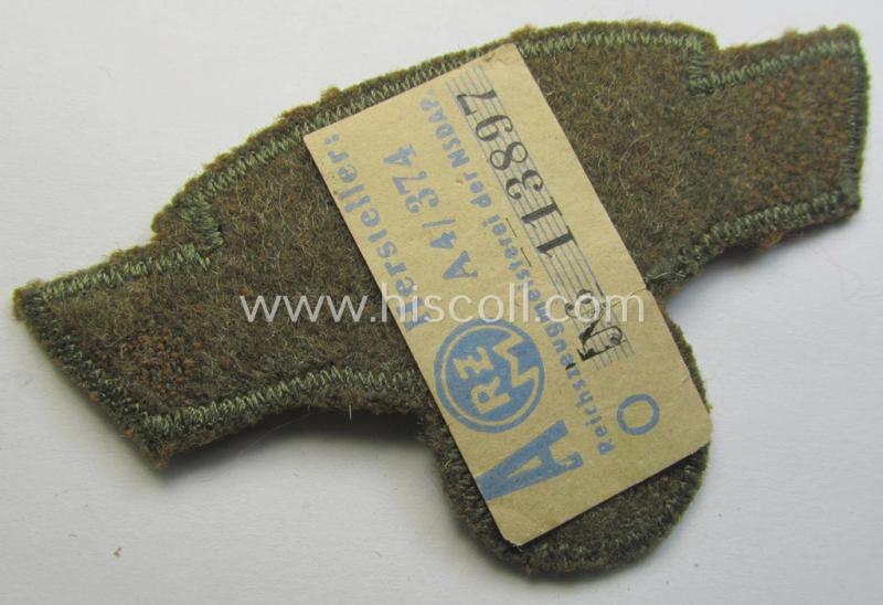 Attractive, greenish-tan-coloured, so-called: N.S.K.K. (ie. 'National Socialistisches Kraftfahr Korps') arm-eagle, still having its original-applied- and/or paper-based 'RzM'-etiket attached
