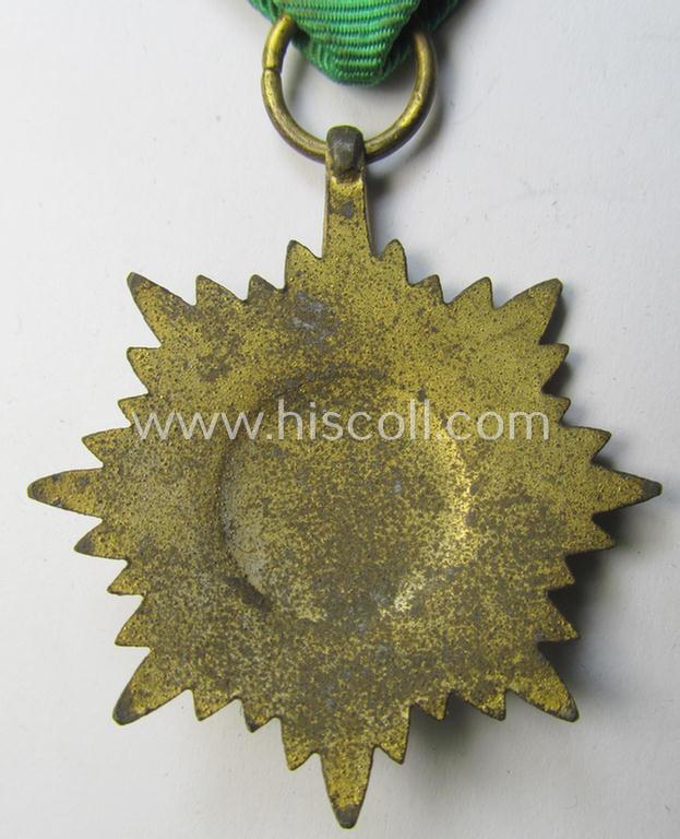 WH-related so-called: 'Verdienstauszeichnung für Angehörige der Ostvölker, 2. Klasse in Gold ohne Schwerter', being a nicely maker- (ie. '100'-) marked- and/or: 'Feinzink'-based example that comes mounted on its period ribbon