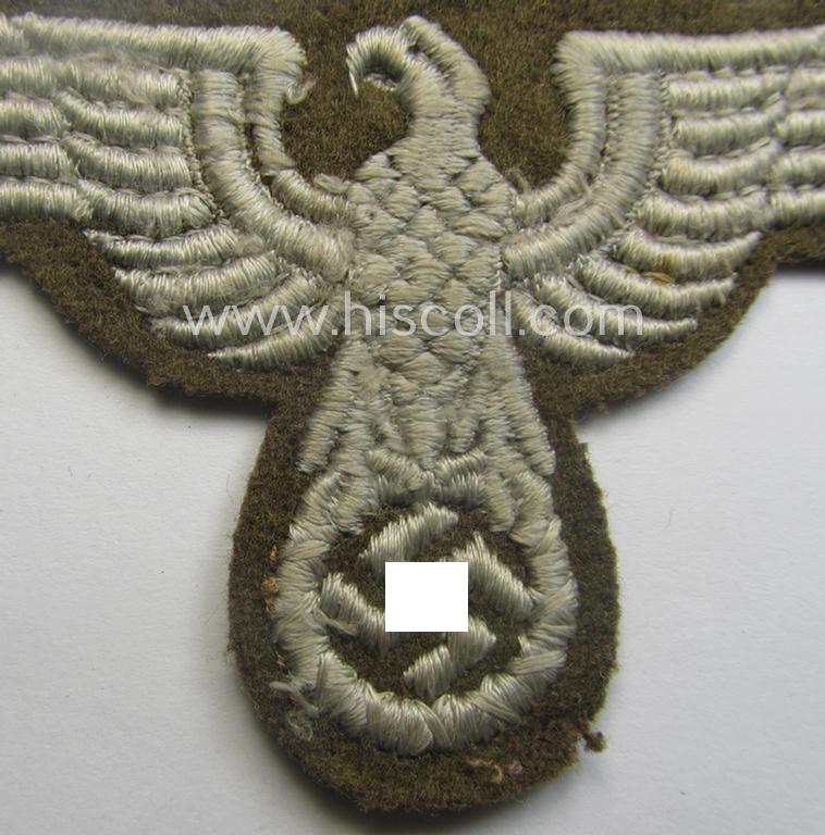 Machine-embroidered arm-eagle (ie. 'Ärmeladler') as was specifically intended for usage on the brownish-green-coloured tunics of officials of the: 'Reichsministerium für besetzte Ostgebiete' (ie. 'R.M.b.O.')