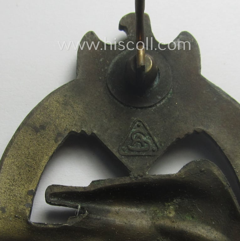 'Panzerkampfabzeichen in Bronze' (or: bronze-class panzer-assault badge or PAB) being a clearly maker- (ie. 'AS' in a triangle-) marked- and/or typical zinc- (ie. 'Feinzink'-) based specimen as was procuced by a to date unknown maker