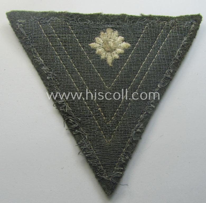 WH (Heeres) 'Armwinkel' (or: arm-chevron) as executed on typical field-grey-coloured wool as was specifically intended for usage by a soldier with the (unusually encountered!) rank of: 'Stabsgefreiter'