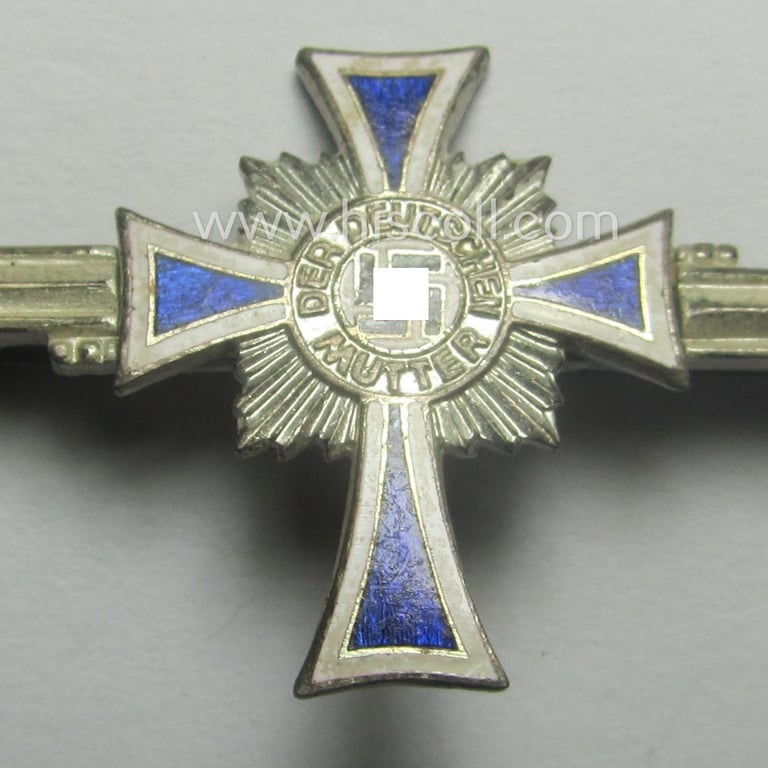 Rarely found miniature of an: 'Ehrenkreuz der deutschen Mutter - zweite Stufe' (or: silver-class mothers'-cross) being a non-maker-marked example that comes mounted onto a (rarely observed!) bar (ie. 'Spange')