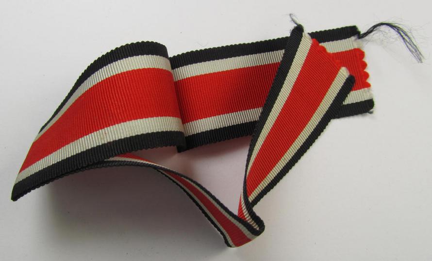 Neat spare-part: a non-confectioned- (ie. full length- ie. 29 cms. long-sized-) ribbon (ie. 'Bandabschitt') as was intended for the: 'Eisernes Kreuz II. Klasse' and that comes in an overall very nice- (ie. 'virtually mint ie. unissued'-), condi...