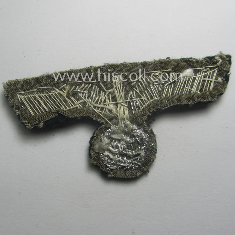 Clearly used- and/or cap-removed, WH (Heeres) officers'-pattern, visor-cap eagle (ie. 'Mützenadler für Schirmmütze') being a hand-embroidered example that comes mounted onto a darker-green-coloured- and/or woolen-based background