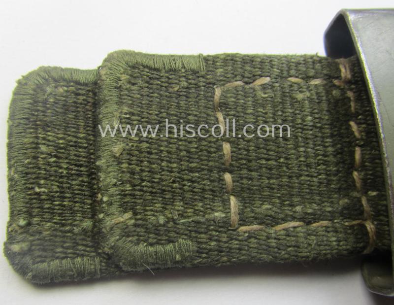 WH (Heeres) 'tropical-issued' belt-buckle being a clearly maker- (ie. 'IKA 41'-) marked, field-grey-coloured example that comes mounted onto its original, greenish-coloured- (and/or: 'webbing'-based-) tab