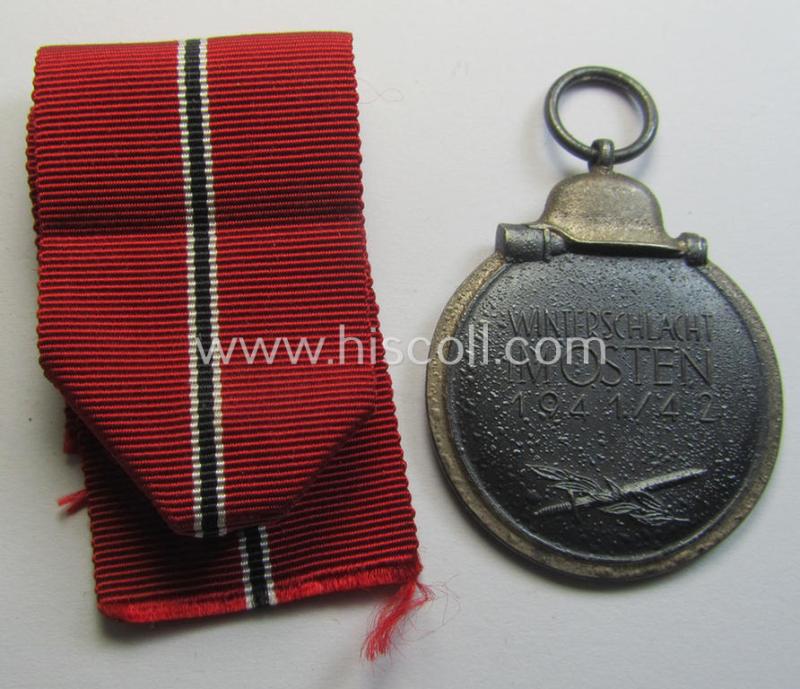 Attractive medal-set: 'Winterschlacht im Osten 1941-42' being a maker- (ie. '14'-) marked- (and/or 'Feinzink'-based) specimen by the maker: 'L.Chr. Lauer' and that comes together with its (minimally confectioned) ribbon (ie. 'Bandabschnitt'...