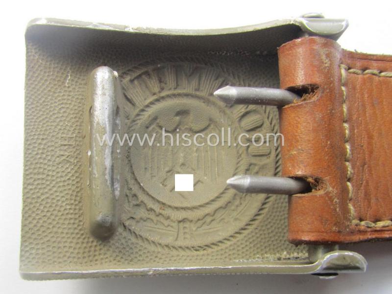 WH (Heeres) 'standard-pattern', field-grey-toned- and aluminium-based belt-buckle being a maker- (ie. 'Hermann Knoller - Pforzheim'-) marked- and/or: '1939'-dated example that comes mounted onto its leather-based tab