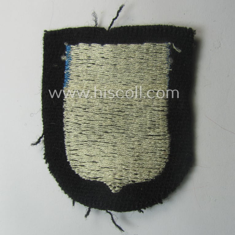 Waffen-SS 'volunteer'-arm-shield as was intended for usage by soldiers of the: '20. Waffen-Grenadier-Division der SS' (ie. 'estnische Nr. 1') and that comes in a 'virtually mint- ie. unissued', condition
