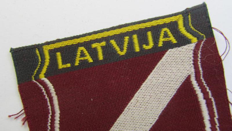 Superb - and truly rarely seen! - locally produced(!), 'Waffen-SS'-type armshield as executed in the so-called: 'semi-BeVo'-pattern entitled: 'Latvia' as was merely intended for usage by the members of the: 'Latvian Legion'