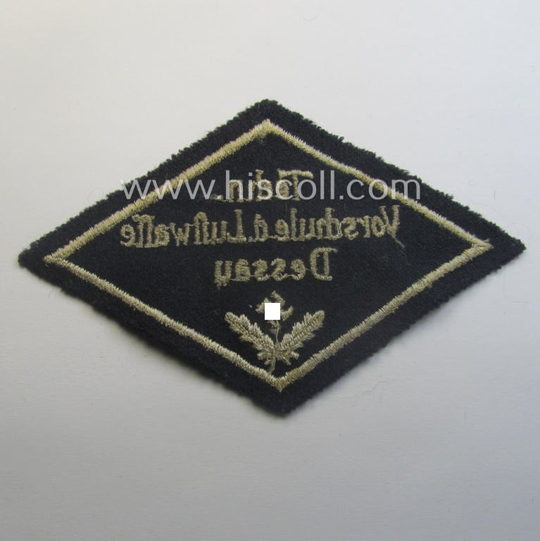 Unusual, HJ ('Hitlerjugend' ie. 'Flieger HJ'-) specialist armbadge (or: 'Schulabzeichen') depicting the text: 'Techn. Vorschule d. Luftwaffe - Dessau' and that comes in an overall nice- (ie. moderately used and/or tunic-removed-), condition