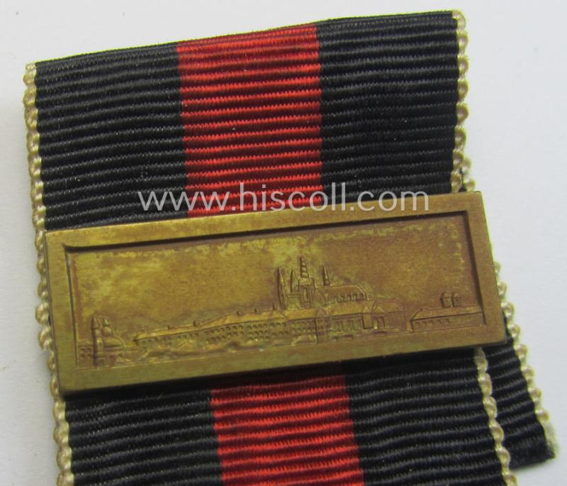 WH Czech-occupation- (ie. 'Anschluss'-) medal: '1. Oktober 1938' being a neat (albeit minimally tarnished) example that comes mounted onto its period ribbon and that shows a firmly (and period!) attached 'Prager Burg-Spange'