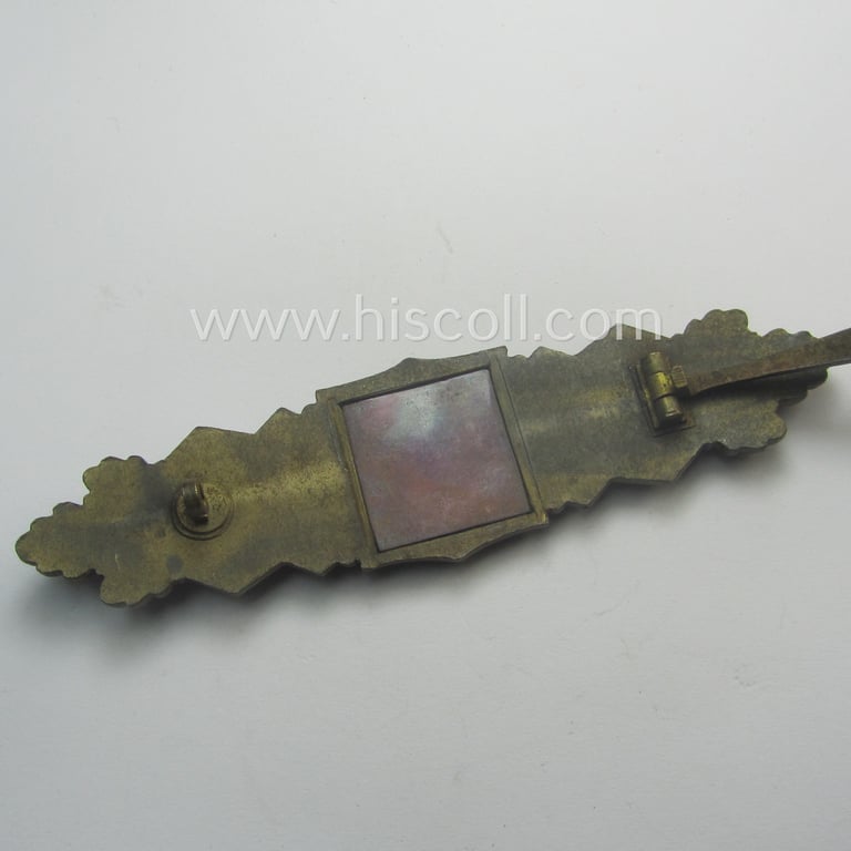 'Nahkampfspange in Bronze' (or: bronze-class close-combat clasp ie. CCC) being a (typical) non-maker-marked- and/or minimally converse-shaped specimen as was (I deem) produced by the maker- (ie. 'Hersteller') 'Steinhauer & Lück'